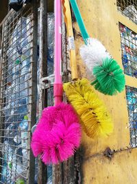 Close-up of multi colored umbrellas hanging on building