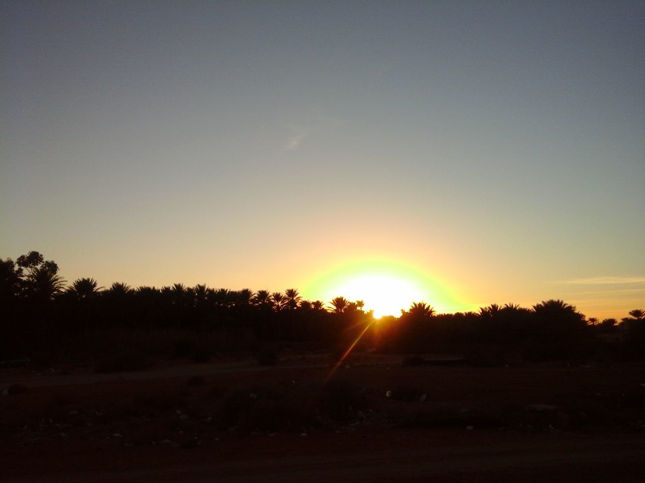 sunset, sun, copy space, clear sky, tranquil scene, tranquility, scenics, silhouette, orange color, landscape, beauty in nature, tree, nature, sunlight, idyllic, field, sky, outdoors, no people, sunbeam