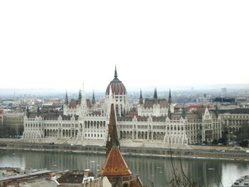 Buildings in city against clear sky