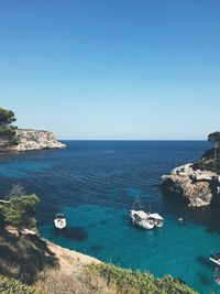 Scenic view of sea against clear blue sky