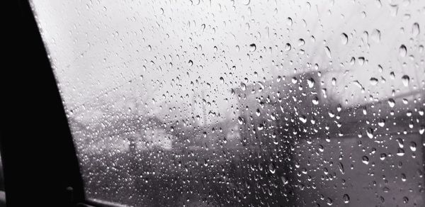 Full frame shot of wet glass window in rainy season