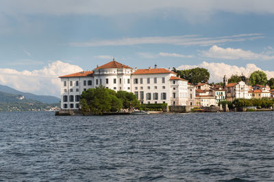 Building by sea against sky