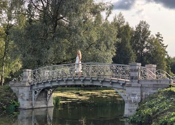 Arch bridge over river against sky