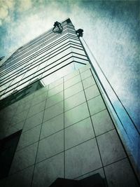 Low angle view of modern building against cloudy sky