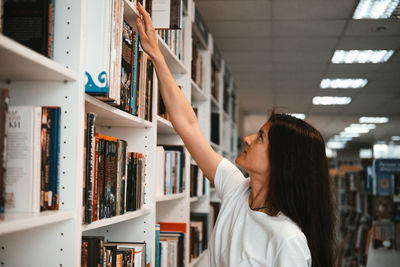 Side view of woman reading book