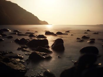 Scenic view of sea against sky at sunset