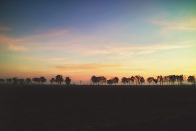 Scenic view of landscape against sky at sunset