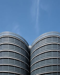 Low angle view of modern building against blue sky