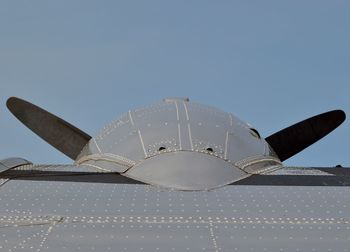 Low angle view of airplane flying against clear sky