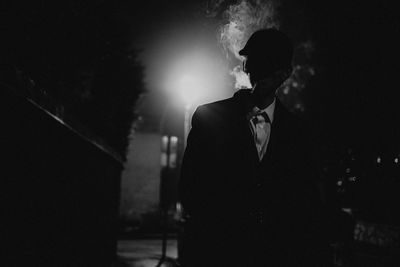 Young man smoking at night