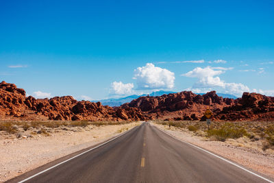 Empty road and rock formations against sky at valley of fire state park