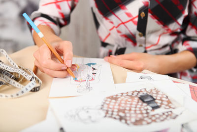 Woman painting on paper