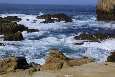 Waves splashing on rocks at beach