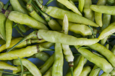 Full frame shot of green chili peppers for sale in market