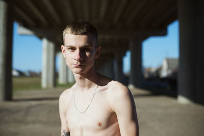 Portrait of shirtless young man outdoors