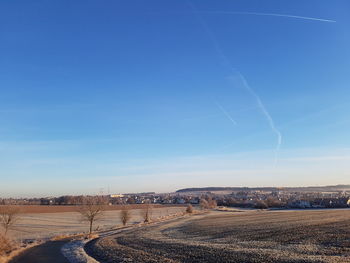 Scenic view of landscape against blue sky