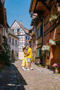 People walking on street amidst buildings