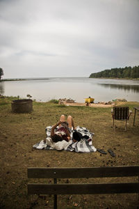 Woman relaxing on lakeshore