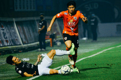 People playing soccer on field