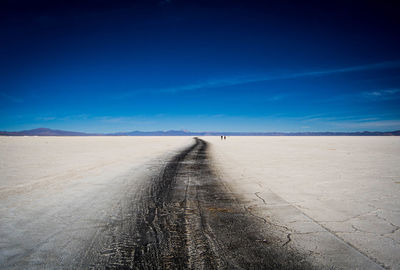 Scenic view of road against blue sky