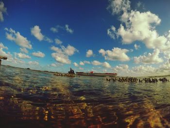 Scenic view of sea against cloudy sky