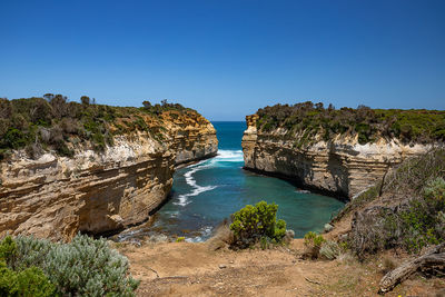 Panoramic shot of rocks against clear blue sky