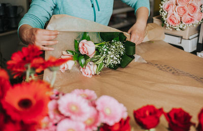 Midsection of person holding rose bouquet