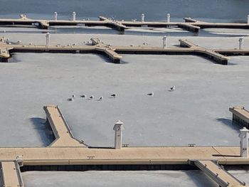 High angle view of pier over frozen lake during winter
