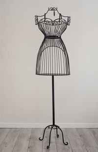 Low angle view of electric lamp against wall