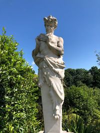 Low angle view of statue against clear blue sky