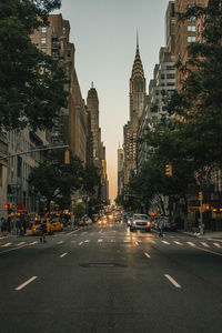 View of city street and buildings against sky