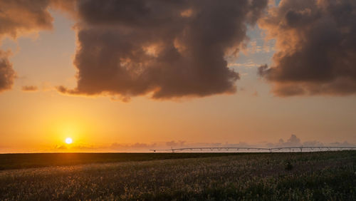 Scenic view of sunset over land