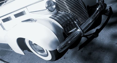 Car parked by cars moving