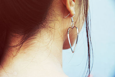 Close-up of woman with heart shape earring