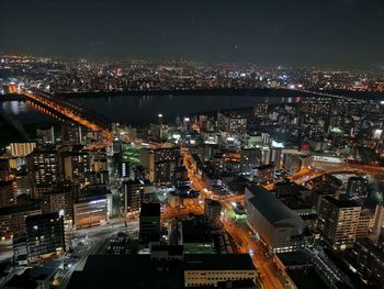 High angle view of illuminated city buildings at night