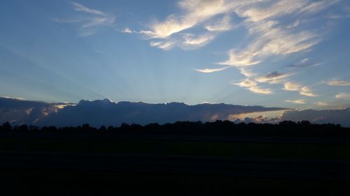 Scenic view of silhouette landscape against sky at sunset