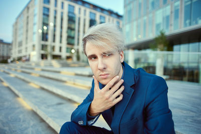 Businessman looking away while sitting outdoors