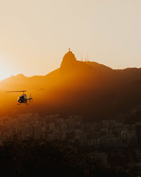 Scenic view of buildings in city against sky during sunset