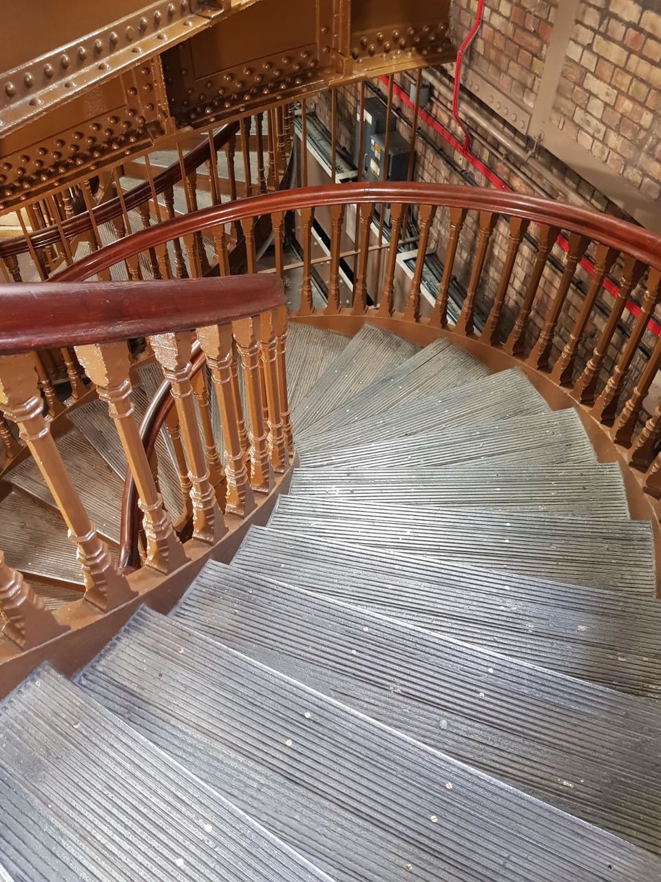 HIGH ANGLE VIEW OF SPIRAL STAIRCASE IN WAREHOUSE