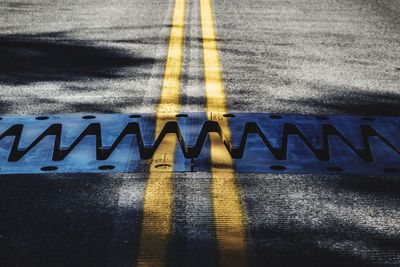 High angle view of arrow sign on road