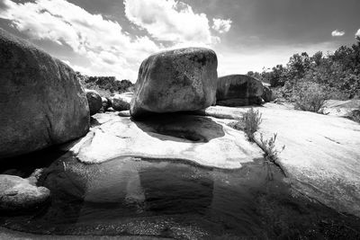 Rocks on shore against sky