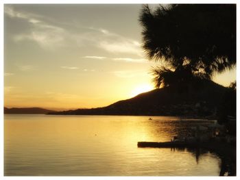 Scenic view of lake against sky at sunset