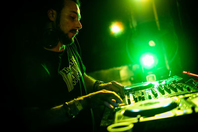 Man playing with illuminated lights at night