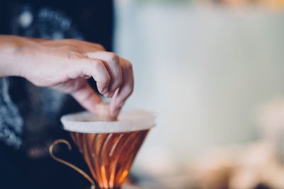 Close-up of hand holding coffee cup