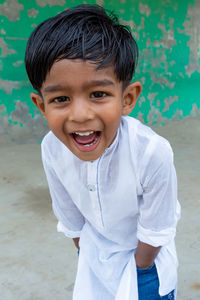 Portrait of smiling boy standing outdoors