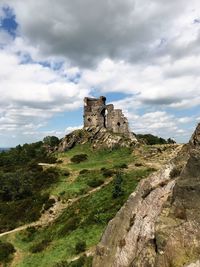 Low angle view of historical building against cloudy sky