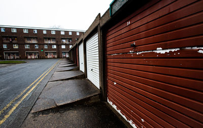 Rows of garages and social housing on a council estate in the north of england