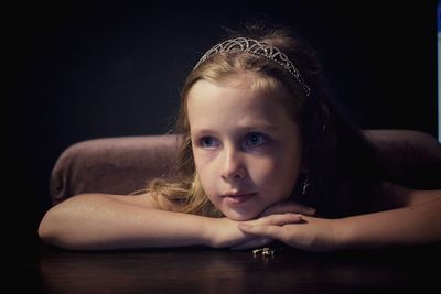 Close-up girl looking away while sitting at table