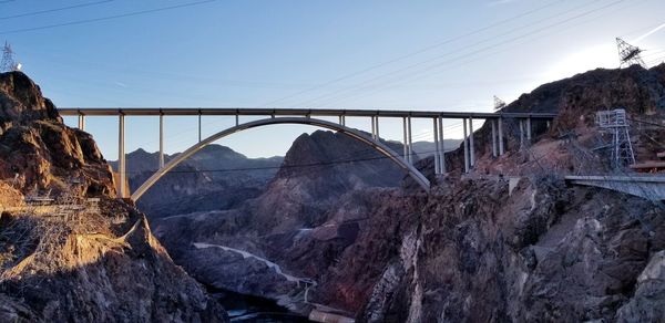 Bridge over mountains against sky