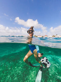 Man in sea against sky